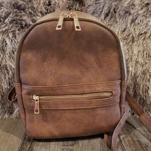 Brown N. GIL faux leather backpack purse.
